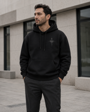 NORVEN Origin Essential Hoodie in black, styled with charcoal tailored trousers